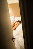 Sleeping woman behind door