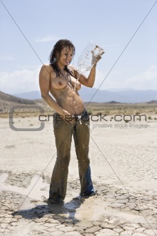 Topless muddy woman.
