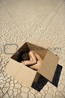 Nude woman in desert.