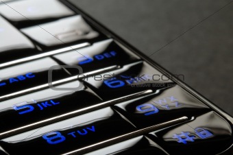 Blue mobile keypad under dark