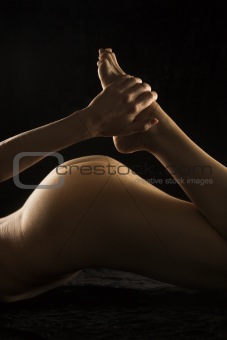 Nude female lying down.