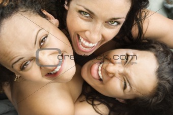 Three women embracing.