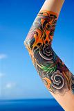 Arm of tattooed woman.