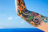 Arm of tattooed woman.