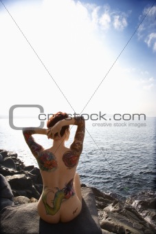Sexy tattooed nude woman.