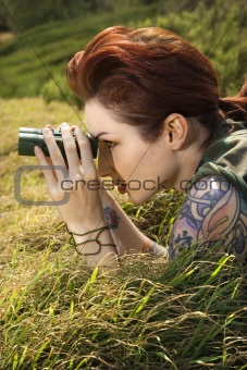 Tattooed woman with binoculars.