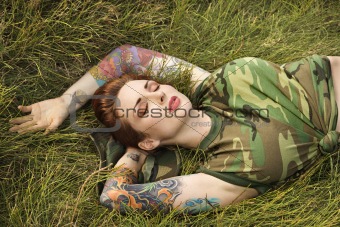Tattooed woman in camouflage.
