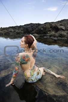 Tattooed woman in bikini.