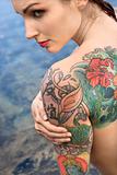 Nude tattooed woman.