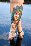 Tattooed woman's legs.