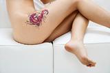 Nude young tattooed woman.