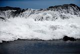 Waves crashing on rocky shore.