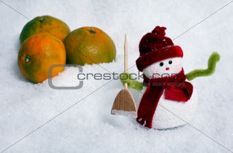 Snowman and apples in snow