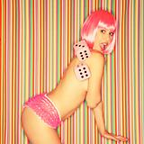 Topless woman in pink wig.
