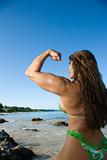 Woman bodybuilder at beach.