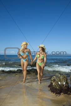 Women bodybuilders at beach.