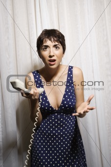Woman holding telephone.
