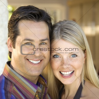 Caucasian couple smiling.