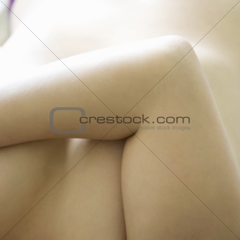 Woman\'s elbow covering breasts.