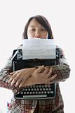 Woman holding typewriter.