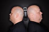Bald twin men with telephone.