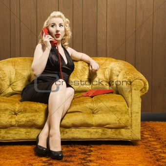 Woman talking on red phone.