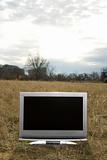 Television in grassy field.