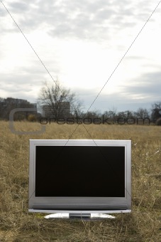 Television in grassy field.