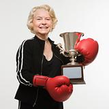 Senior woman with boxing trophy.