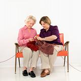 Two women knitting.