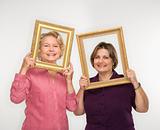 Women holding picture frames.