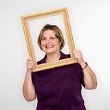 Woman holding picture frame.