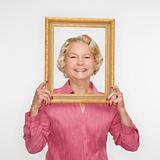 Woman holding picture frame.