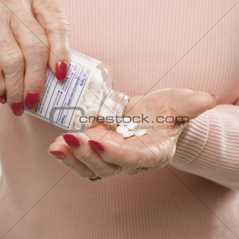 Hands holding pills.