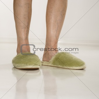 Female feet wearing slippers.