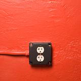Wall with electrical outlet.