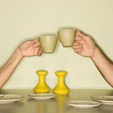 Hands toasting cups.