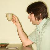 Man holding coffee cup.
