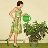 Woman watering plant.