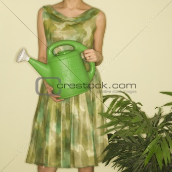Woman holding watering can.