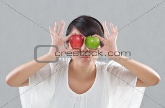 young pretty girl shows an expression with apples