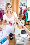 Caucasian woman is paying items 