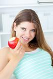 Positive woman eating an apple