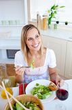 Positive young woman eating a salad