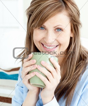 Positive attractive businesswoman holding a cup 