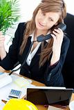 Portrait of a busy businesswoman talking on phone 