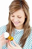 Ill young woman holding  pills