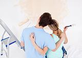 Young couple looking at a painted wall 