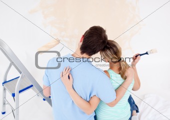 Young couple looking at a painted wall 