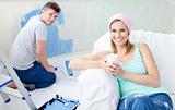 Bright woman relaxing boyfriend paint the room